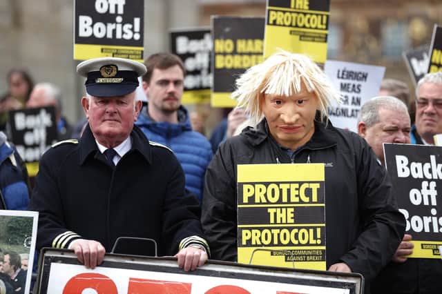 A man dressed as a customs officer and another dressed as Boris Johnson with protesters from Border Communities Against Brexit outside Hillsborough Castle during a visit by Prime Minister Boris Johnson to Northern Ireland for talks with Stormont parties. Picture: Liam McBurney/PA Wire