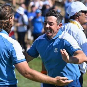 Tommy Fleetwood and Rory McIlroy celebrate winning their match in the opening session in the Ryder Cup in Rome. Picture: Alberto Pizzoli/AFP via Getty Images.