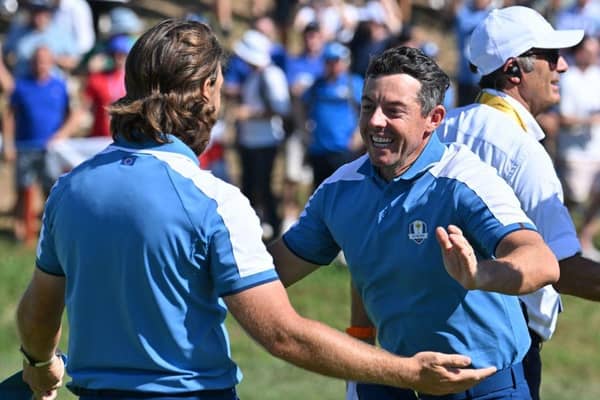 Tommy Fleetwood and Rory McIlroy celebrate winning their match in the opening session in the Ryder Cup in Rome. Picture: Alberto Pizzoli/AFP via Getty Images.