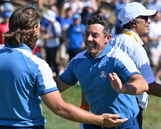 Tommy Fleetwood and Rory McIlroy celebrate winning their match in the opening session in the Ryder Cup in Rome. Picture: Alberto Pizzoli/AFP via Getty Images.