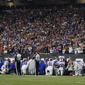 The Buffalo Bills players pray for teammate Damar Hamlin during the first half of an NFL football game against the Cincinnati Bengals.