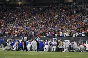 The Buffalo Bills players pray for teammate Damar Hamlin during the first half of an NFL football game against the Cincinnati Bengals.