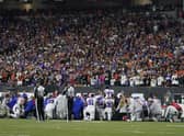 The Buffalo Bills players pray for teammate Damar Hamlin during the first half of an NFL football game against the Cincinnati Bengals.