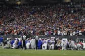 The Buffalo Bills players pray for teammate Damar Hamlin during the first half of an NFL football game against the Cincinnati Bengals.