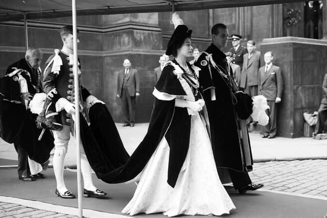 Queen Elizabeth II and the Duke of Edinburgh walk to Signet Library from St Giles' Cathedral during her coronation visit to Edinburgh in 1953.