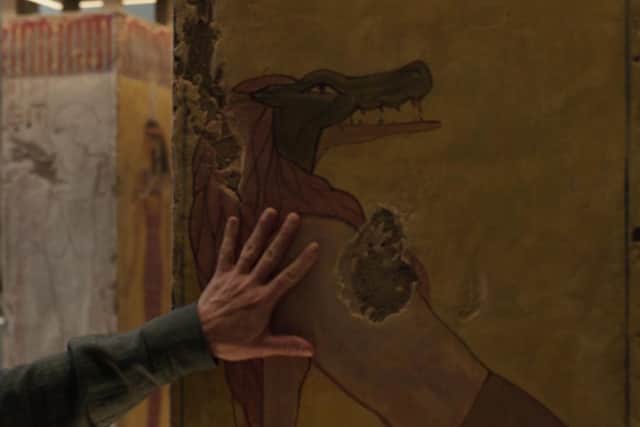 Marc touches a carving of Ammit while discussing her with Dr Arthur Harrow in the National Portrait Gallery. Photo: Marvel / Disney.