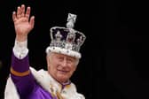 King Charles III wearing the Imperial state Crown, waves from the Buckingham Palace balcony after viewing the Royal Air Force fly-past in central London in May  last year after his coronation. Photo: STEFAN ROUSSEAU/POOL/AFP via Getty Images)