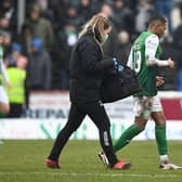Hibernian's Demetri Mitchell goes off injured during the match against Arbroath.