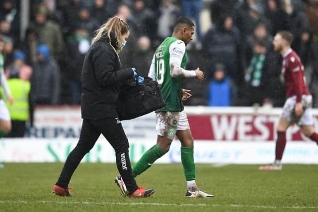 Hibernian's Demetri Mitchell goes off injured during the match against Arbroath.