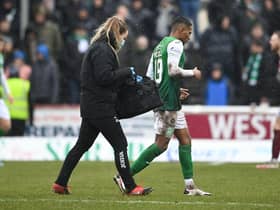 Hibernian's Demetri Mitchell goes off injured during the match against Arbroath.