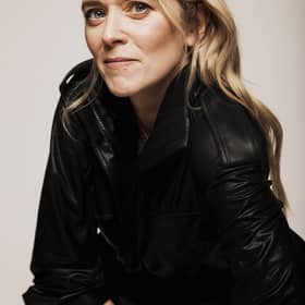 The presenter has taken on the role of a teacher at home to kids and is recording her podcast to stay sane