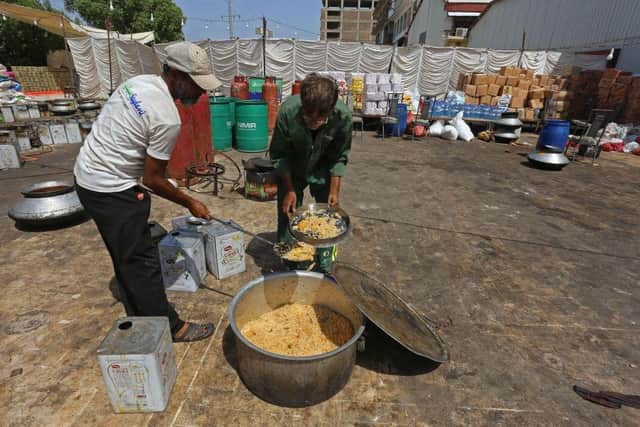 Workers of 'Saylani welfare trust' cook food for flood-affected people in Hyderabad in Sindh province. Monsoon rains have submerged a third of Pakistan, claiming at least 1,190 lives since June and unleashing powerful floods that have washed away swathes of vital crops and damaged or destroyed more than a million homes.