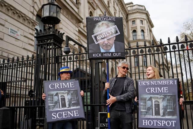 Demonstrators outside the entrance to 10 Downing Street yesterday (Photo by Tolga Akmen/AFP via Getty Images)