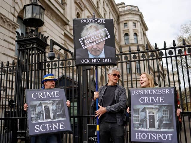 Demonstrators outside the entrance to 10 Downing Street yesterday (Photo by Tolga Akmen/AFP via Getty Images)