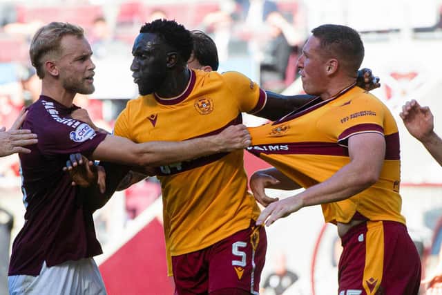 Motherwell's Bevis Mugabi (centre) tries to seperate a scuffle between teammate Dan Casey (right) and Hearts' Nathaniel Atkinson. (Photo by Sammy Turner / SNS Group)