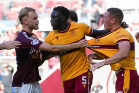 Motherwell's Bevis Mugabi (centre) tries to seperate a scuffle between teammate Dan Casey (right) and Hearts' Nathaniel Atkinson. (Photo by Sammy Turner / SNS Group)
