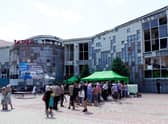People wait in line at a food distribution organised by volunteers in the city of Mariupol.