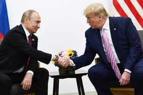 Donald Trump and Vladimir Putin at the G20 summit in Osaka in 2019 (Picture: Brendan Smialowski/AFP)