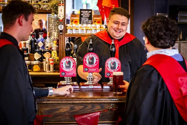 Napier graduates Joshua Scanlan, Kieran Clark and Ethan Pender enjoy a pint of 'Must Be Napier'