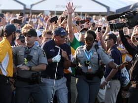 Phil Mickelson is assisted by security as he is followed up the 18th fairway by a gallery of fans in the final round of the 2021 PGA Championship at Kiawah Island. Picture: Patrick Smith/Getty Images.