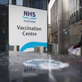 A member of the public outside the main entrance to the coronavirus mass vaccine centre at the Edinburgh International Conference Centre. Picture date: Monday February 1, 2021.