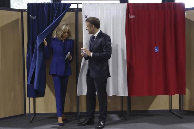 French President Emmanuel Macron and his wife Brigitte Macron leave the voting booth after voting for the second round of the legislative elections in Le Touquet-Paris-Plage, northern France. Picture: Mohammed Badra, Pool via AP