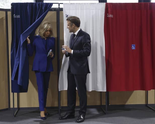 French President Emmanuel Macron and his wife Brigitte Macron leave the voting booth after voting for the second round of the legislative elections in Le Touquet-Paris-Plage, northern France. Picture: Mohammed Badra, Pool via AP