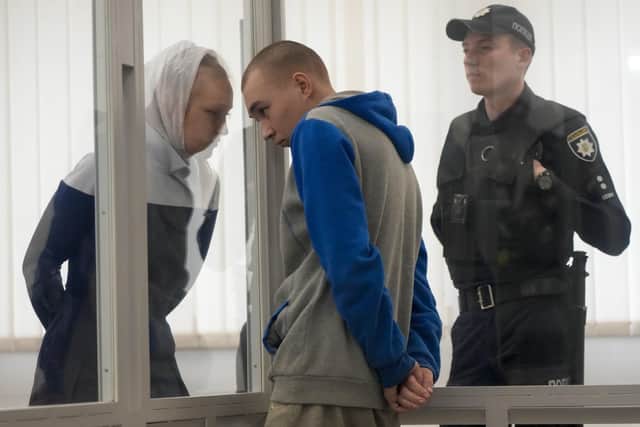 Russian Sgt. Vadim Shishimarin listens to his translator during a court hearing in Kyiv, Ukraine, Monday, May 23, 2022.