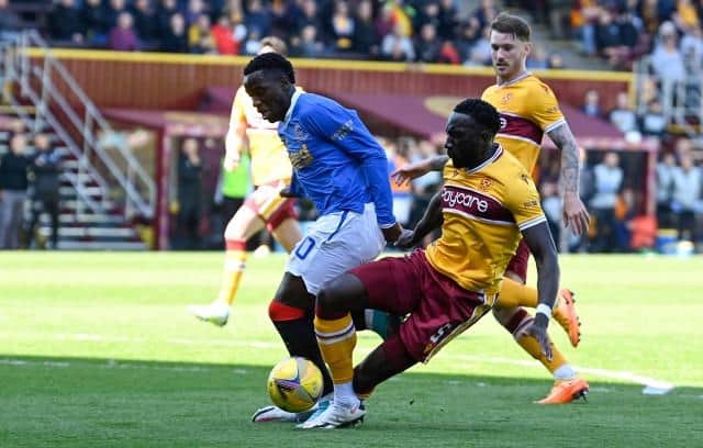 MOTHERWELL, SCOTLAND - APRIL 23: Rangers' Fashion Sakala (L) is brought down by Motherwell's Bevis Mugabi in the box during a cinch Premiership match between Motherwell and Rangers at Fir Park, on April 23, 2022, in Motherwell, Scotland.  (Photo by Rob Casey / SNS Group)