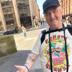 John showcasing his new Spiderman tattoo