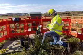 An engineer works on the new full-fibre broadband network in Scotland.
