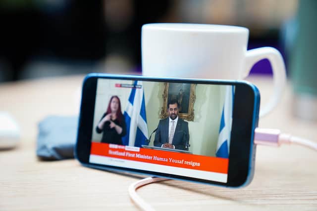 First Minister Humza Yousaf can be seen on a phone as he speaks during a press conference at Bute House, his official residence in Edinburgh where he said he will resign as SNP leader. Picture: Jane Barlow/PA Wire