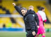 Hibs manager Lee Johnson celebrates the 4-1 victory over Livingston at full time with the visiting fans.