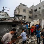 People search through buildings destroyed during Israeli air raids in the southern Gaza Strip. Heading into a third week of heavy bombing from Israel, Gaza buckles under a shortage of basic needs including fuel, whilst several neighbourhoods on the Gaza strip have been wiped out and thousands have died.