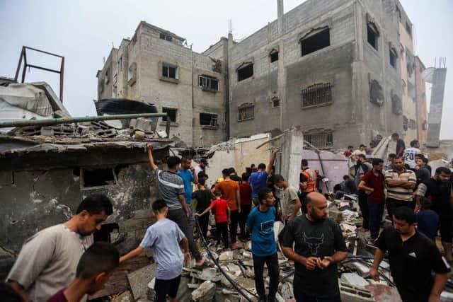 People search through buildings destroyed during Israeli air raids in the southern Gaza Strip. Heading into a third week of heavy bombing from Israel, Gaza buckles under a shortage of basic needs including fuel, whilst several neighbourhoods on the Gaza strip have been wiped out and thousands have died.