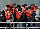 A group of people thought to be migrants are brought in to Dover, Kent, following a small boat incident in the Channel. Under a scheme designed to crack down on migrants landing on British shores after crossing the Channel in small boats, the UK intends to provide those deemed to have arrived unlawfully with a one-way ticket to Rwanda. Picture date: Friday April 15, 2022.