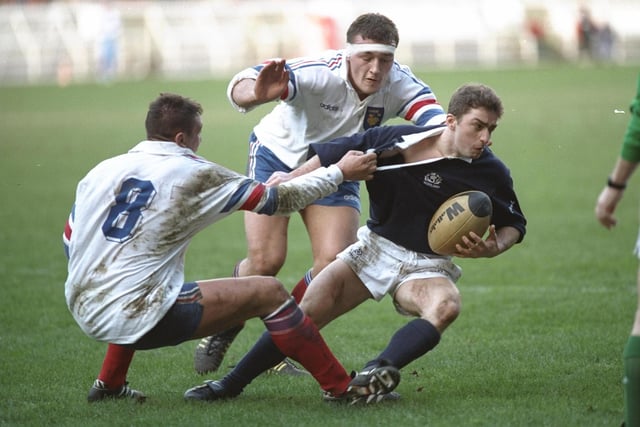 Bryan Redpath, the Scotland scrum-half, is held by Phillipe Benetton of France during the 1995 Five Nations match at Parc des Princes. Redpath formed an all-Melrose half-back partnership with Craig Chalmers as Scotland won 23-21. They were joined by their club-mate Craig Joiner on the wing. A fourth Melrose player, Doddie Weir, came off the bench to replace Damian Cronin. The Greenyards club were the pre-eminent side in Scotland at the time, winning the title five years out of six between 1992 and 1997.