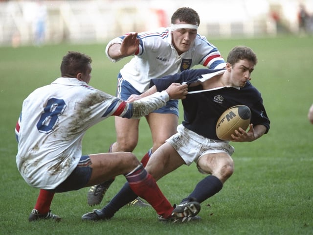 Bryan Redpath, the Scotland scrum-half, is held by Phillipe Benetton of France during the 1995 Five Nations match at Parc des Princes. Redpath formed an all-Melrose half-back partnership with Craig Chalmers as Scotland won 23-21. They were joined by their club-mate Craig Joiner on the wing. A fourth Melrose player, Doddie Weir, came off the bench to replace Damian Cronin. The Greenyards club were the pre-eminent side in Scotland at the time, winning the title five years out of six between 1992 and 1997.