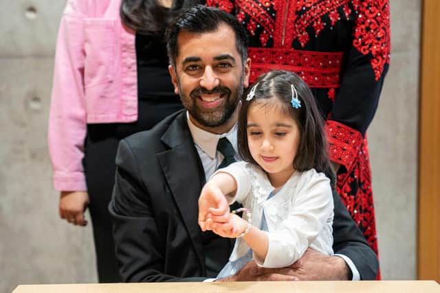 Newly elected leader of the Scottish National Party, Humza Yousaf, poses with his daughter Amal after signing the nomination form to become First Minister for Scotland. Picture: Jane Barlow/POOL/AFP via Getty Images