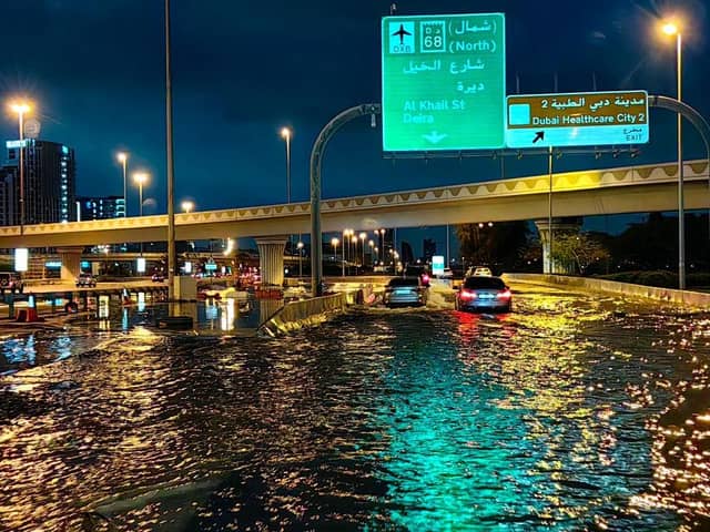 Motorists drive along a flooded street following heavy rains in Dubai.