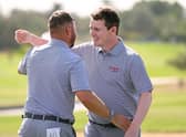 Jordan Smith and Bob Macintyre celebrates after winning their morning foursomes on day two of the Hero Cup at Abu Dhabi Golf Club. Picture: Ross Kinnaird/Getty Images.