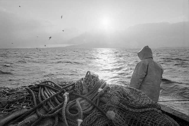 A member of the crew at the stern on a showery evening. PIC: David Gordon.