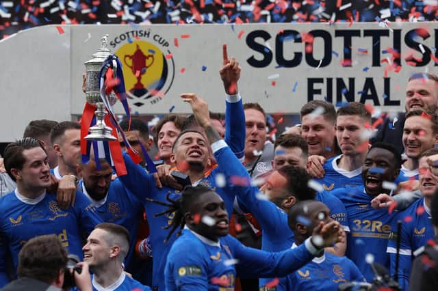 Rangers captain James Tavernier holds aloft the Scottish Cup in the midst of his jubilant team-mates after the Hampden victory over Hearts. (Photo by Ian MacNicol/Getty Images)