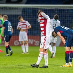 Jamie Hamilton buries his head in his shirt after the full-time whistle sounded in Dingwall. Picture: SNS