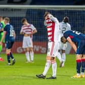 Jamie Hamilton buries his head in his shirt after the full-time whistle sounded in Dingwall. Picture: SNS