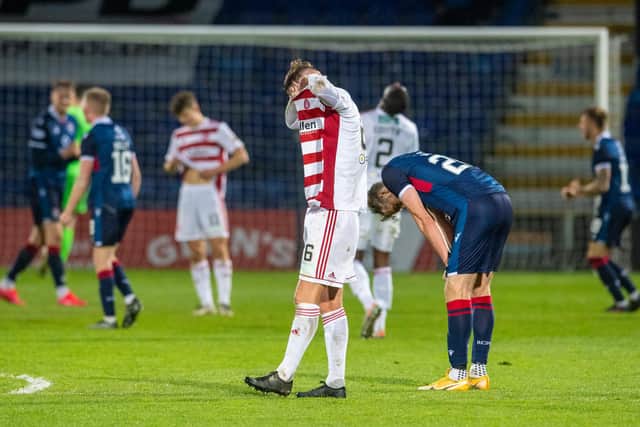 Jamie Hamilton buries his head in his shirt after the full-time whistle sounded in Dingwall. Picture: SNS