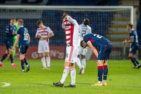 Jamie Hamilton buries his head in his shirt after the full-time whistle sounded in Dingwall. Picture: SNS