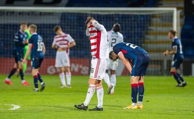 Jamie Hamilton buries his head in his shirt after the full-time whistle sounded in Dingwall. Picture: SNS