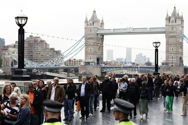 Members of the public in the queue on the South Bank near to Tower Bridge, London, as they wait to view Queen Elizabeth II lying in state ahead of her funeral on Monday.