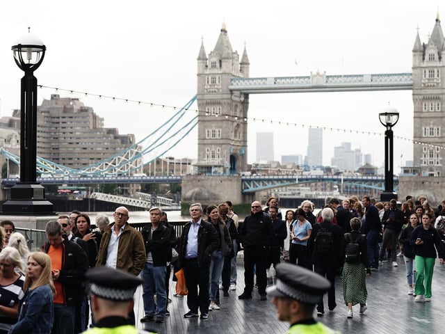 Members of the public in the queue on the South Bank near to Tower Bridge, London, as they wait to view Queen Elizabeth II lying in state ahead of her funeral on Monday.